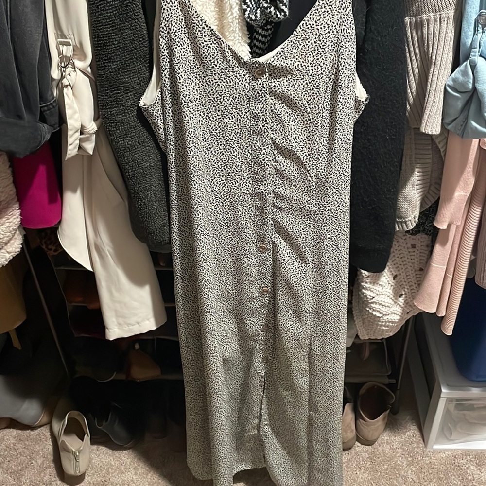 Maxi style bottom front sleeveless dress with tie front detail and slit.